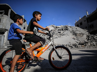 Palestinians gather near a building destroyed by an Israeli airstrike in the Nuseirat refugee camp in central Gaza Strip on August 23, 2024,...