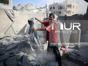 A Palestinian girl stands in despair on the balcony of a damaged apartment near a building destroyed by an Israeli airstrike in the Nuseirat...