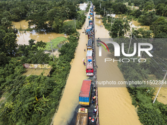 An aerial view of the flooded Dhaka-Chittagong Highway in the Muhuriganj area of Feni district in the Chittagong division of Bangladesh. At...