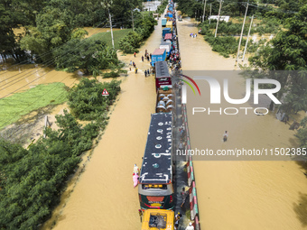 An aerial view of the flooded Dhaka-Chittagong Highway in the Muhuriganj area of Feni district in the Chittagong division of Bangladesh. At...