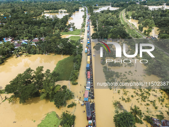 An aerial view of the flooded Dhaka-Chittagong Highway in the Muhuriganj area of Feni district in the Chittagong division of Bangladesh. At...