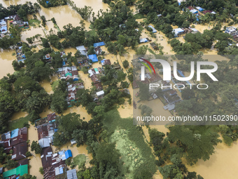 An aerial view shows flooded villages in the Muhuriganj area of Feni district in Chittagong division, Bangladesh, on August 23, 2024. At lea...