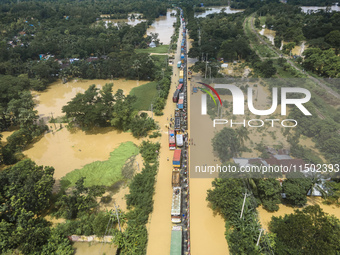 An aerial view of the flooded Dhaka-Chittagong Highway in the Muhuriganj area of Feni district in the Chittagong division of Bangladesh. At...