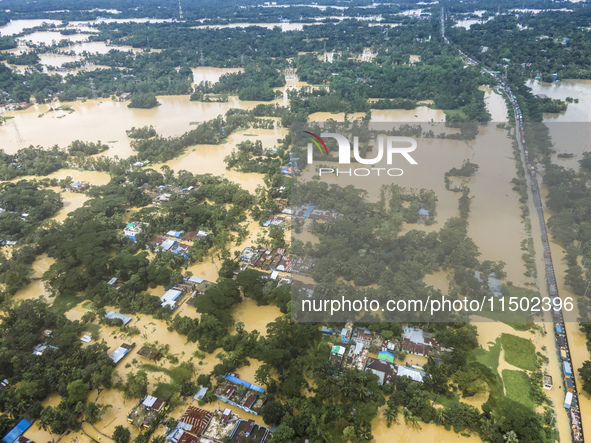 An aerial view shows flooded villages in the Muhuriganj area of Feni district in Chittagong division, Bangladesh, on August 23, 2024. At lea...