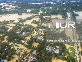 An aerial view shows flooded villages in the Muhuriganj area of Feni district in Chittagong division, Bangladesh, on August 23, 2024. At lea...