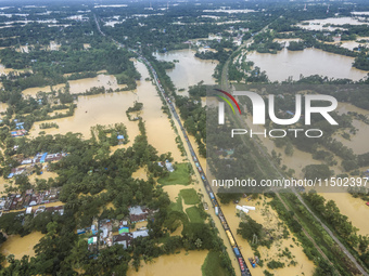 An aerial view shows flooded villages in the Muhuriganj area of Feni district in Chittagong division, Bangladesh, on August 23, 2024. At lea...