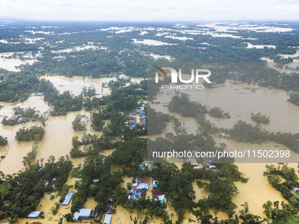 An aerial view shows flooded villages in the Muhuriganj area of Feni district in Chittagong division, Bangladesh, on August 23, 2024. At lea...