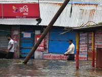 People wade through floodwater in Feni, Chittagong, Bangladesh, on August 23, 2024. (