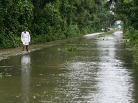 People wade through floodwater in Feni, Chittagong, Bangladesh, on August 23, 2024. (