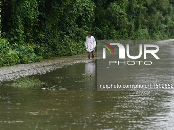 People wade through floodwater in Feni, Chittagong, Bangladesh, on August 23, 2024. (