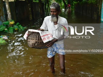 People wade through floodwater in Feni, Chittagong, Bangladesh, on August 23, 2024. (