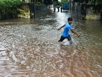 People wade through floodwater in Feni, Chittagong, Bangladesh, on August 23, 2024. (