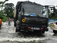 People wade through floodwater in Feni, Chittagong, Bangladesh, on August 23, 2024. (