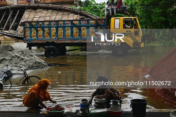 Flood-affected people take shelter in an under-construction building in Feni, Chittagong, Bangladesh, on August 23, 2024. 