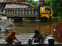 Flood-affected people take shelter in an under-construction building in Feni, Chittagong, Bangladesh, on August 23, 2024. (