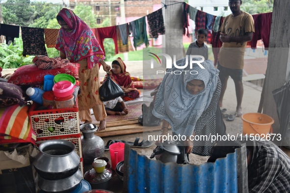 Flood-affected people take shelter in an under-construction building in Feni, Chittagong, Bangladesh, on August 23, 2024. 