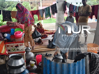 Flood-affected people take shelter in an under-construction building in Feni, Chittagong, Bangladesh, on August 23, 2024. (