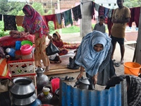 Flood-affected people take shelter in an under-construction building in Feni, Chittagong, Bangladesh, on August 23, 2024. (