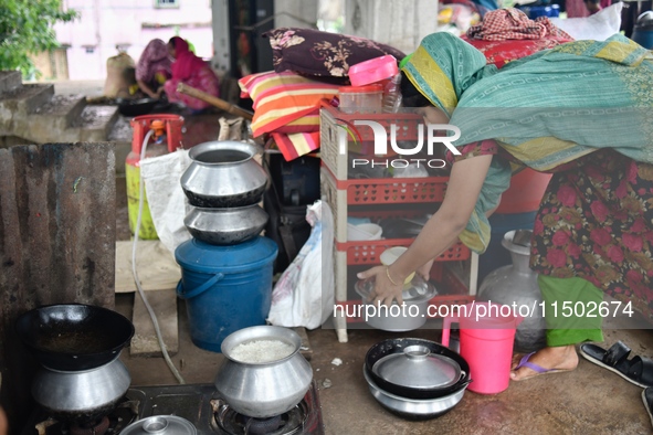 Flood-affected people take shelter in an under-construction building in Feni, Chittagong, Bangladesh, on August 23, 2024. 