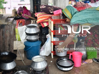 Flood-affected people take shelter in an under-construction building in Feni, Chittagong, Bangladesh, on August 23, 2024. (