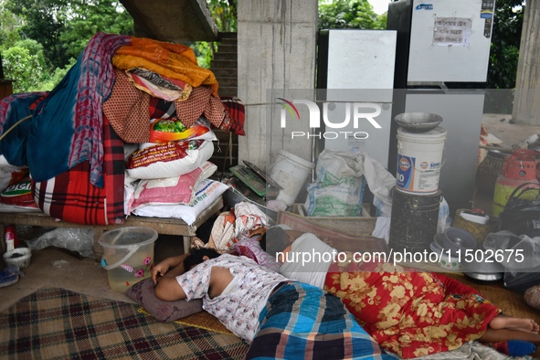 Flood-affected people take shelter in an under-construction building in Feni, Chittagong, Bangladesh, on August 23, 2024. 