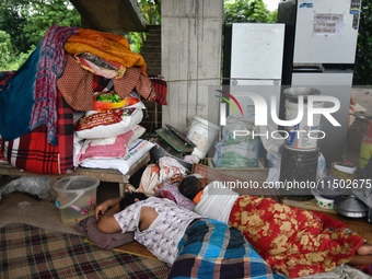 Flood-affected people take shelter in an under-construction building in Feni, Chittagong, Bangladesh, on August 23, 2024. (