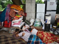 Flood-affected people take shelter in an under-construction building in Feni, Chittagong, Bangladesh, on August 23, 2024. (