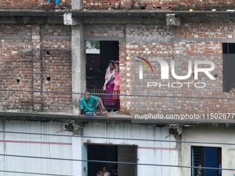 Flood-affected people take shelter in an under-construction building in Feni, Chittagong, Bangladesh, on August 23, 2024. (