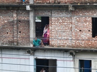 Flood-affected people take shelter in an under-construction building in Feni, Chittagong, Bangladesh, on August 23, 2024. (