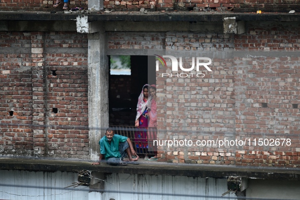 Flood-affected people take shelter in an under-construction building in Feni, Chittagong, Bangladesh, on August 23, 2024. 