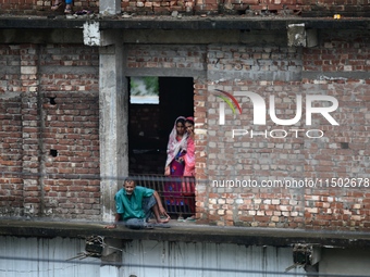 Flood-affected people take shelter in an under-construction building in Feni, Chittagong, Bangladesh, on August 23, 2024. (