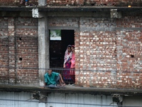 Flood-affected people take shelter in an under-construction building in Feni, Chittagong, Bangladesh, on August 23, 2024. (