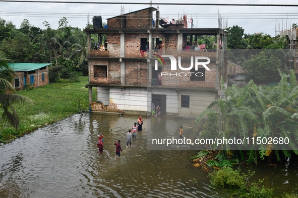 Flood-affected people take shelter in an under-construction building in Feni, Chittagong, Bangladesh, on August 23, 2024. 