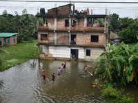 Flood-affected people take shelter in an under-construction building in Feni, Chittagong, Bangladesh, on August 23, 2024. (