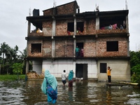 Flood-affected people take shelter in an under-construction building in Feni, Chittagong, Bangladesh, on August 23, 2024. (