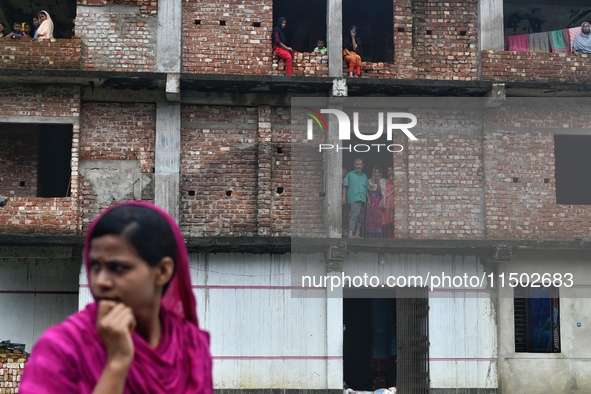 Flood-affected people take shelter in an under-construction building in Feni, Chittagong, Bangladesh, on August 23, 2024. 