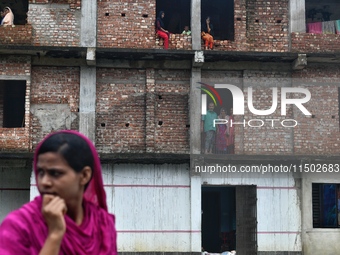 Flood-affected people take shelter in an under-construction building in Feni, Chittagong, Bangladesh, on August 23, 2024. (