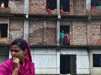 Flood-affected people take shelter in an under-construction building in Feni, Chittagong, Bangladesh, on August 23, 2024. (