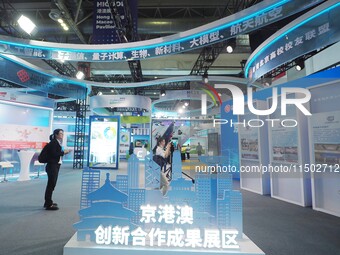 Visitors visit the Beijing-Hong Kong-Macao Innovation Cooperation Achievement Exhibition area of HICOOL 2024 Global Entrepreneurs Summit in...