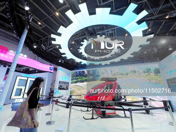 Visitors visit the ''High-rise Building Firefighting Unmanned Aircraft'' at the HICOOL 2024 Global Entrepreneurs Summit in Beijing, China, o...