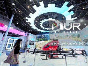 Visitors visit the ''High-rise Building Firefighting Unmanned Aircraft'' at the HICOOL 2024 Global Entrepreneurs Summit in Beijing, China, o...