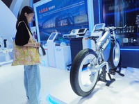 Visitors view a ''spokeless hydrogen bicycle'' at the HICOOL 2024 Global Entrepreneurs Summit in Beijing, China, on August 23, 2024. (