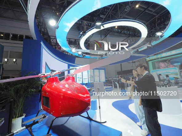 Visitors view an ''unmanned helicopter'' at the HICOOL 2024 Global Entrepreneurs Summit in Beijing, China, on August 23, 2024. 