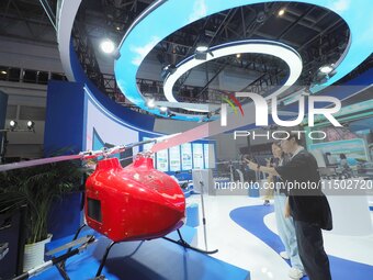 Visitors view an ''unmanned helicopter'' at the HICOOL 2024 Global Entrepreneurs Summit in Beijing, China, on August 23, 2024. (