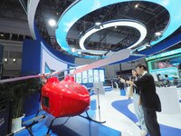 Visitors view an ''unmanned helicopter'' at the HICOOL 2024 Global Entrepreneurs Summit in Beijing, China, on August 23, 2024. (