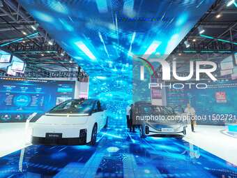 Visitors view a new energy car at the HICOOL 2024 Global Entrepreneurs Summit in Beijing, China, on August 23, 2024. (