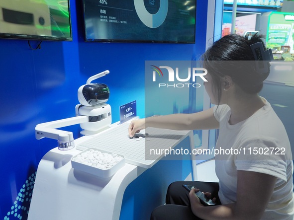 A spectator plays with a Go robot at the HICOOL 2024 Global Entrepreneurs Summit in Beijing, China, on August 23, 2024. 