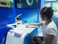 A spectator plays with a Go robot at the HICOOL 2024 Global Entrepreneurs Summit in Beijing, China, on August 23, 2024. (