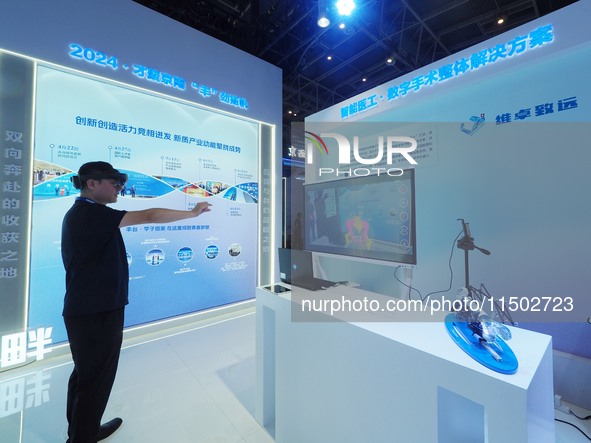 Visitors experience ''digital surgery'' at the HICOOL 2024 Global Entrepreneur Summit in Beijing, China, on August 23, 2024. 