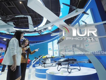 Visitors visit the ''hanging Compound Wing unmanned transport aircraft'' at the HICOOL 2024 Global Entrepreneurs Summit in Beijing, China, o...